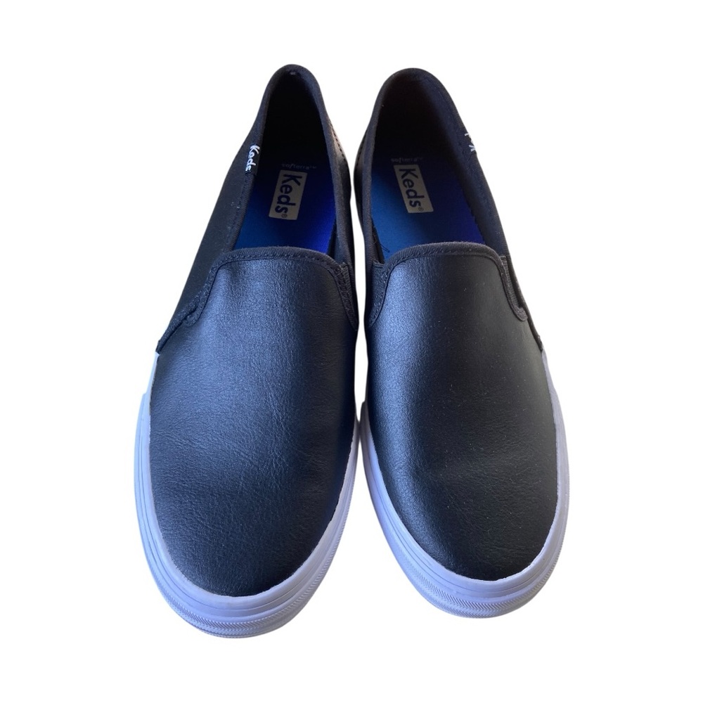 Keds womens slip-on sneakers with a black upper and blue "SoftFoam" insoles